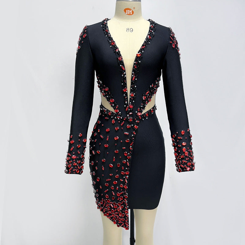 Black dress with red embellishments on a mannequin against a white background