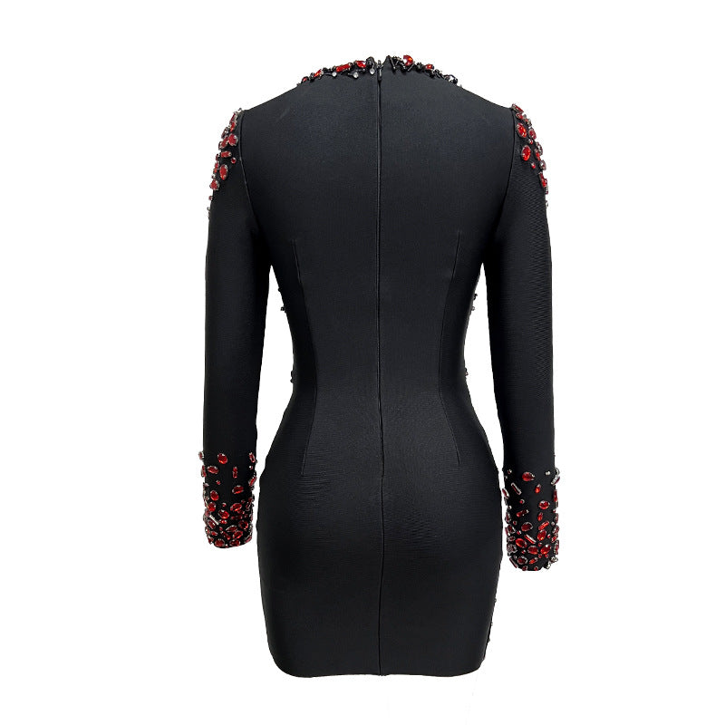 Black dress with red embellishments on sleeves and neckline against a white background