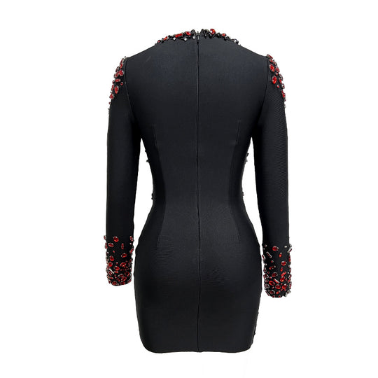 Black dress with red embellishments on sleeves and neckline against a white background